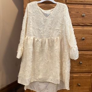 Never worn ladies size small baby doll dress with high low bottom, cream color